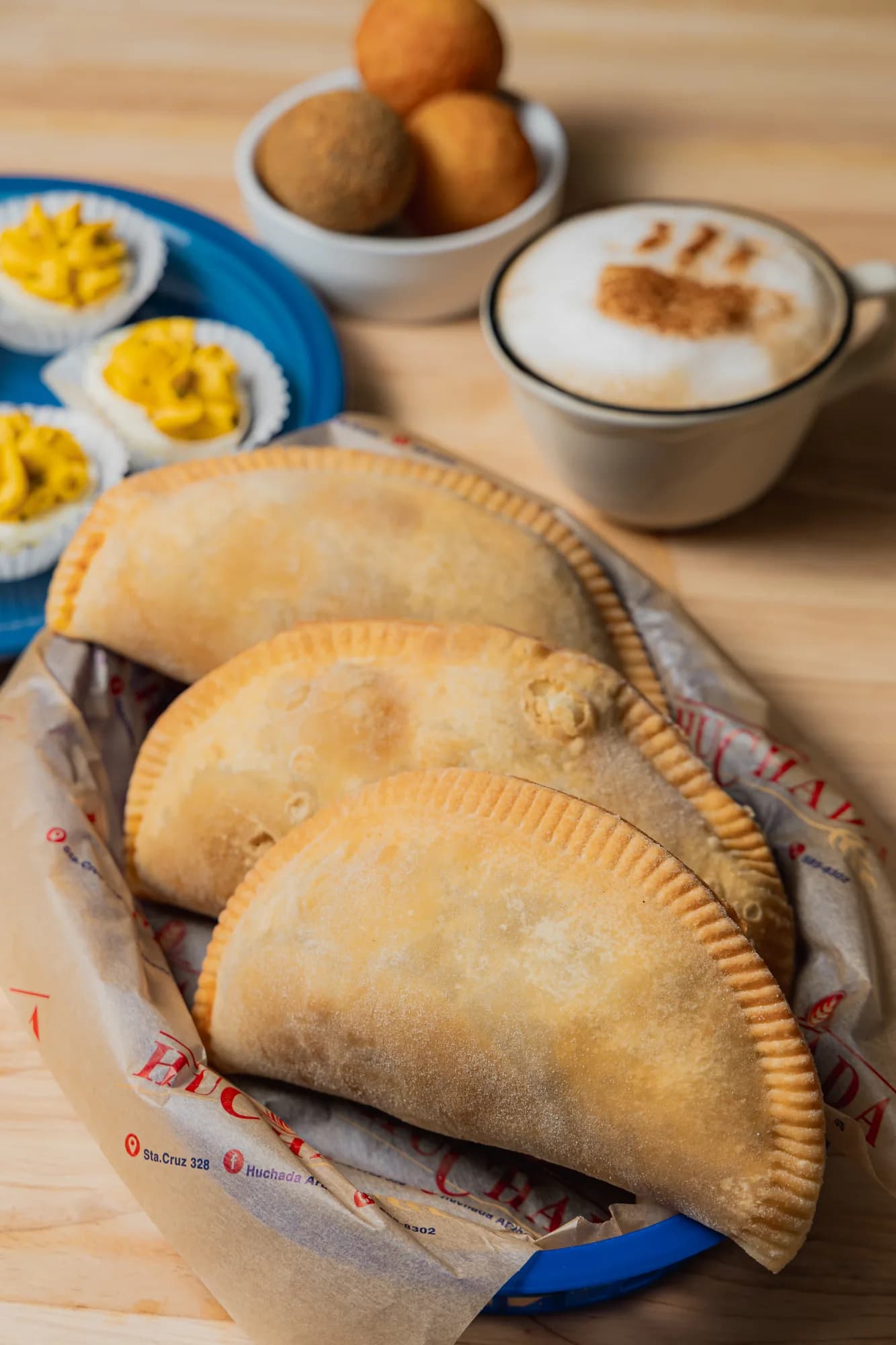 Basket of pastechi with a cappuccino