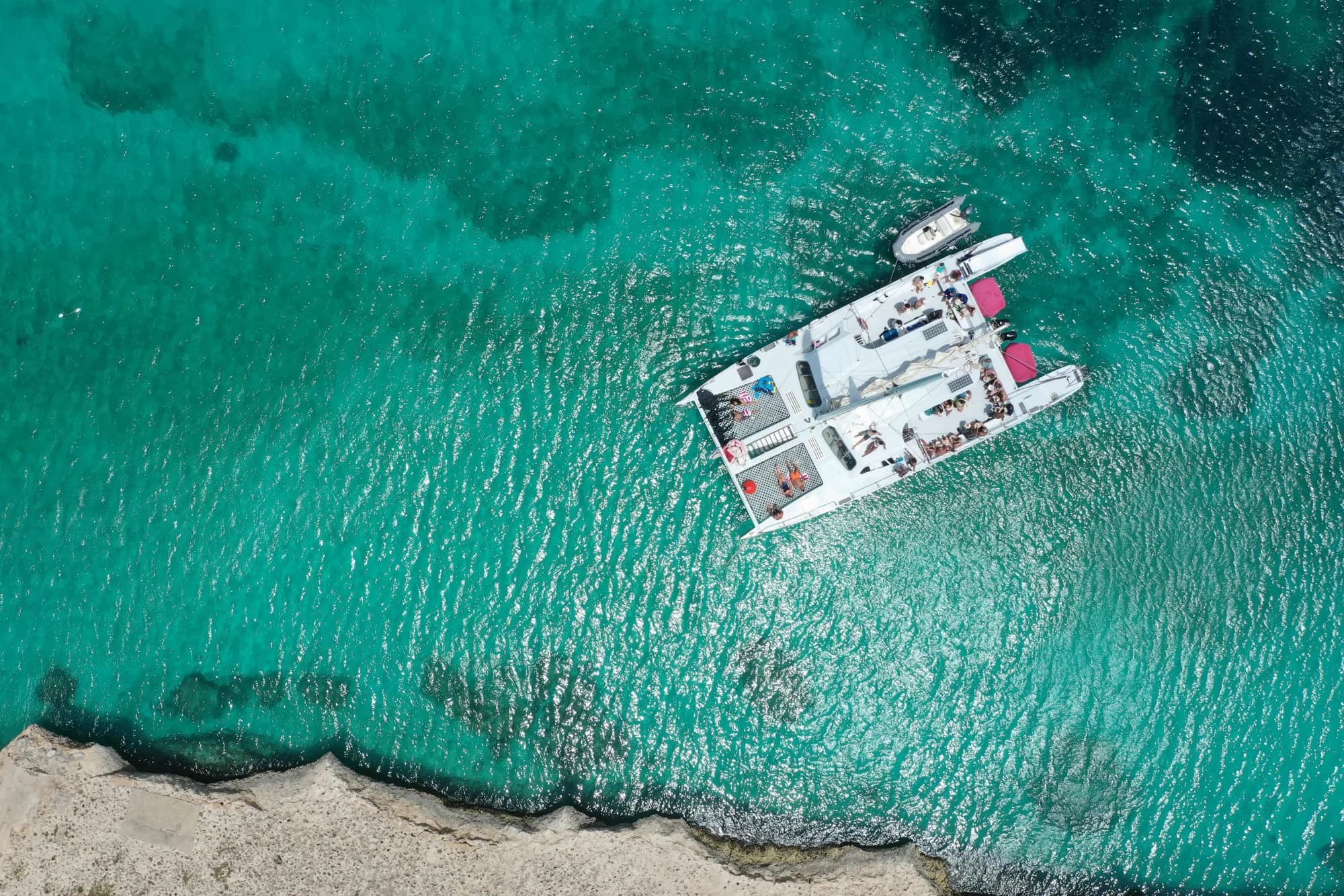 Aerial of catamaran over turquoise water