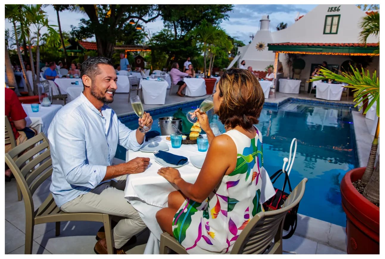 Couple dining beside the pool