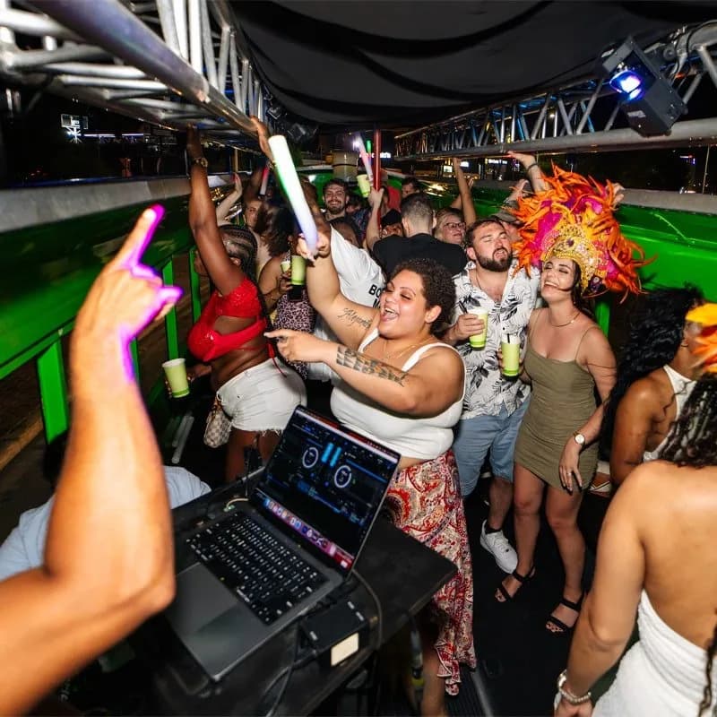 Guests dancing on the bus beside the DJ booth